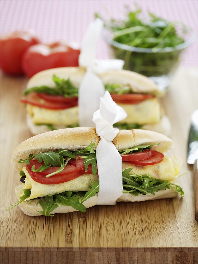 Baguette rolls filled with rocket, egg and tomato