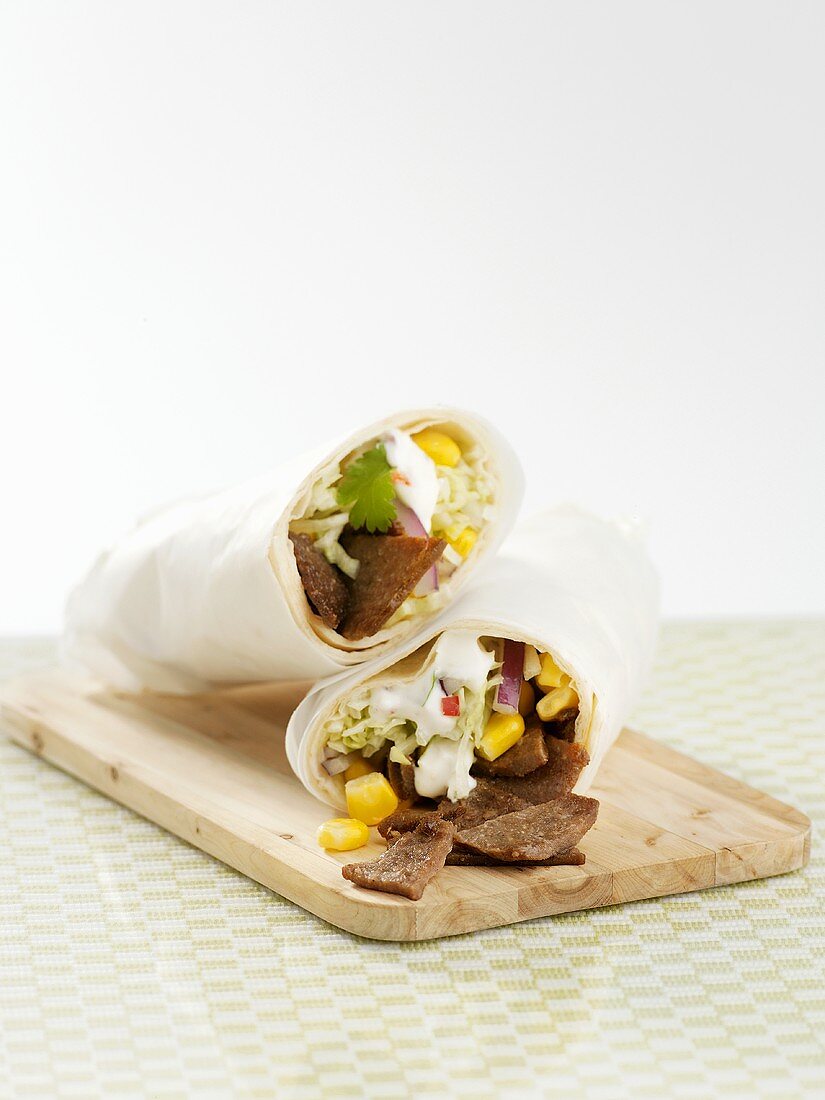Wraps filled with meat, sweetcorn and salad
