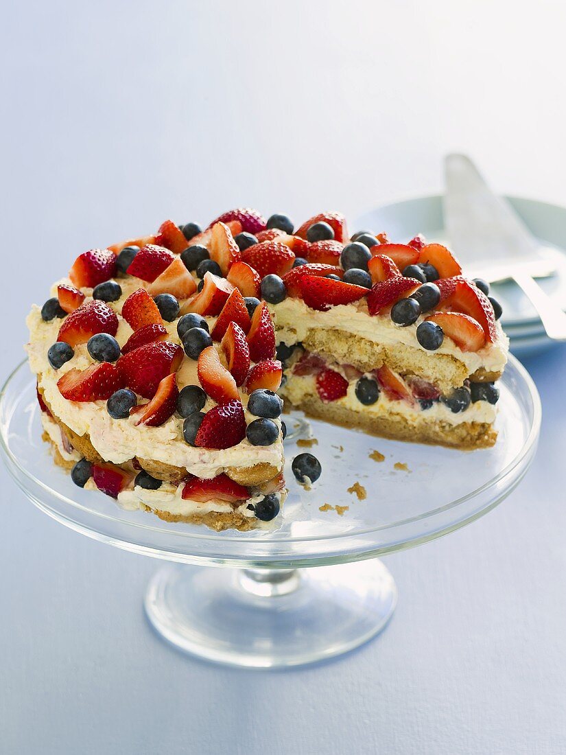 Tiramisu cake with berries, a piece taken