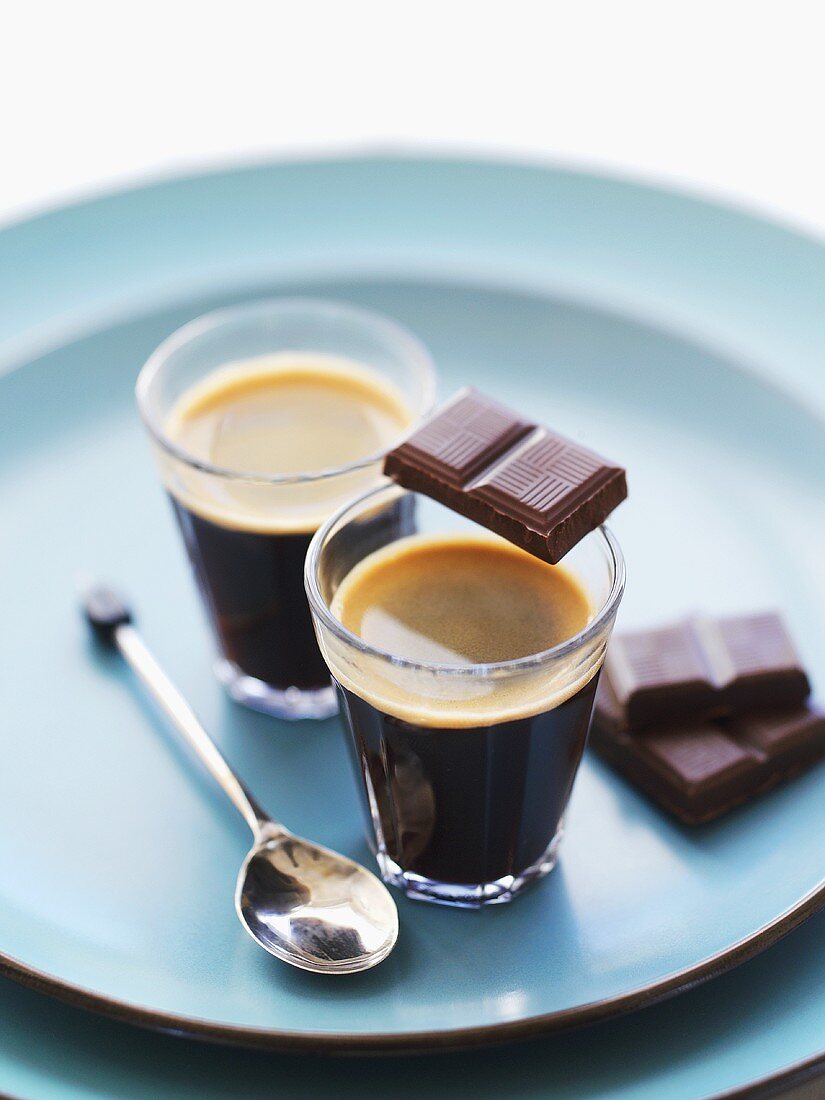 Black coffee with pieces of chocolate