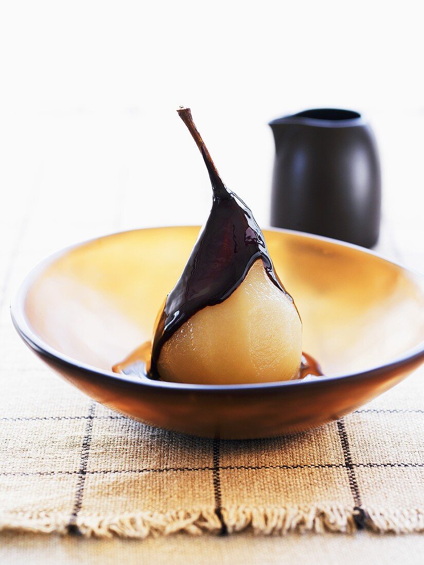 Poached vanilla pear with chocolate sauce