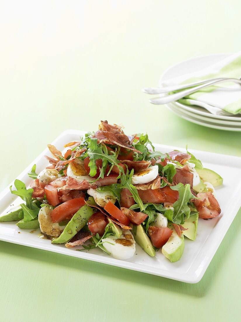 Rocket salad with ham, boiled eggs and avocado
