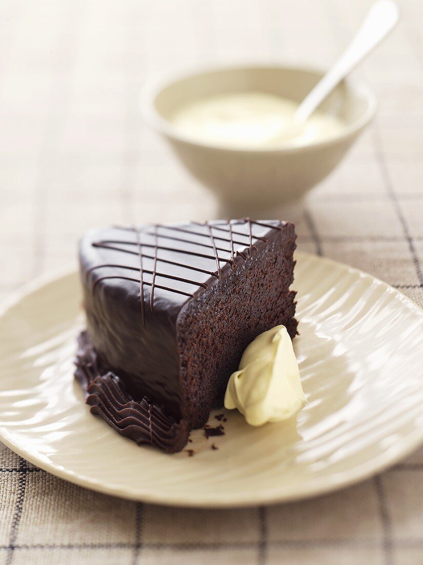 A piece of chocolate cake with whipped cream