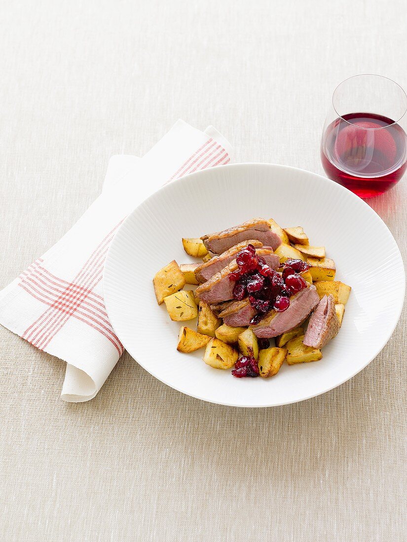 Duck breast with cranberries and fried potatoes