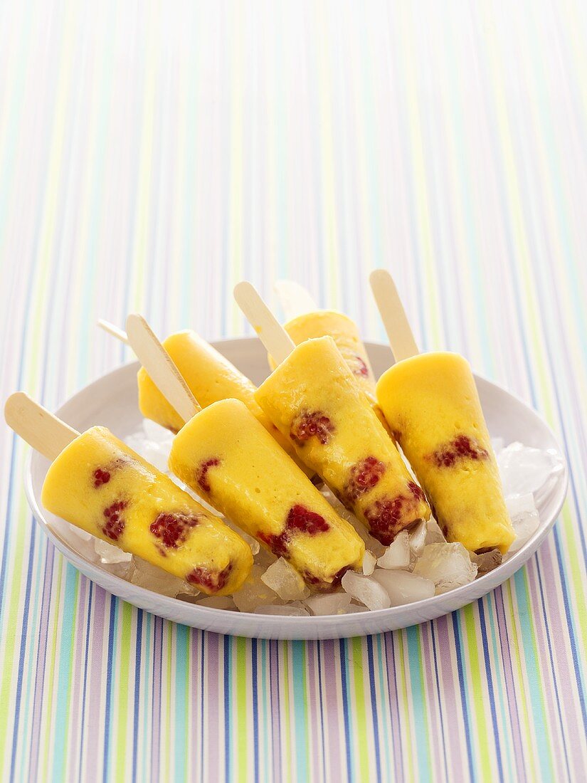 Several mango and raspberry ice lollies