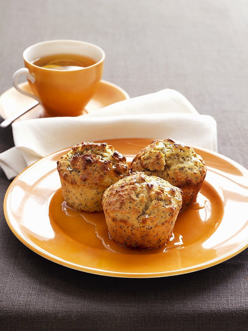 Limetten-Mohn-Muffins und Tasse Tee