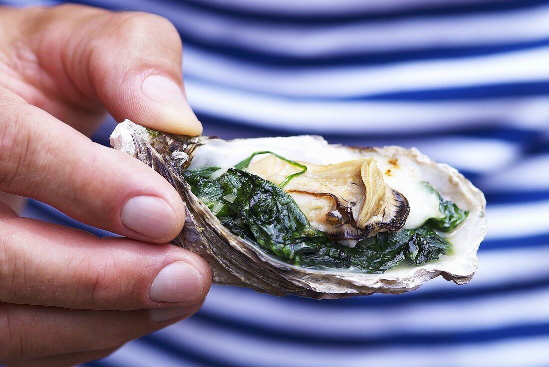 An oyster with spinach and cream