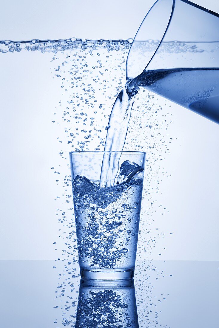 Pouring mineral water into glass