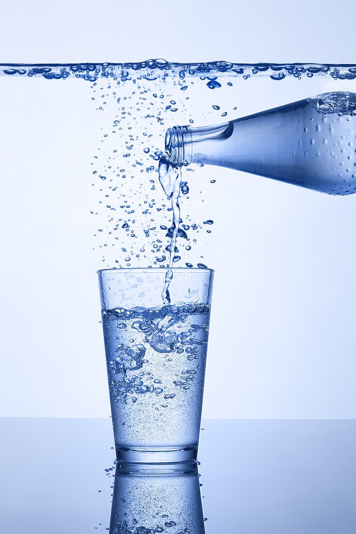 Pouring mineral water into glass