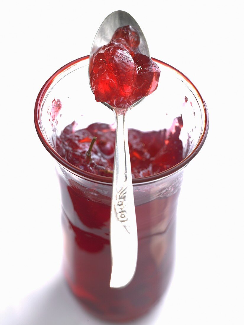 Redcurrant jelly in jar with spoon