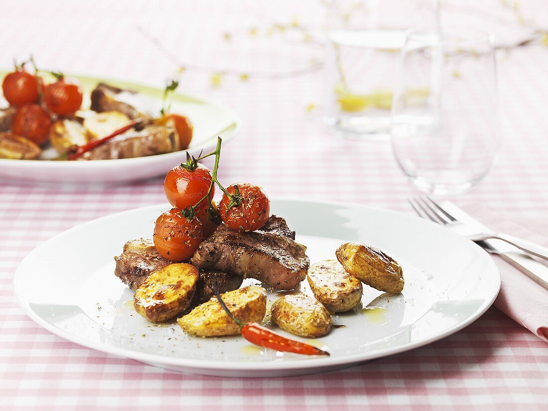 Lamb chops with roasted potatoes and cherry tomatoes