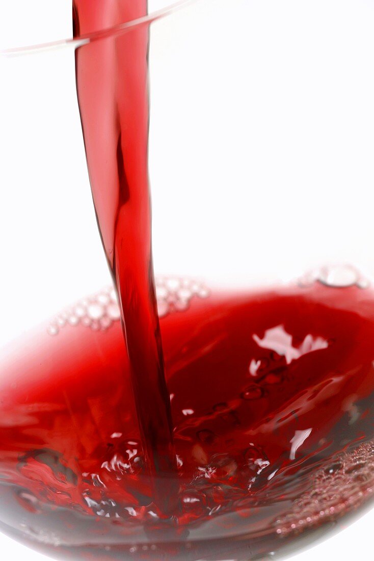 Pouring red wine (close-up)