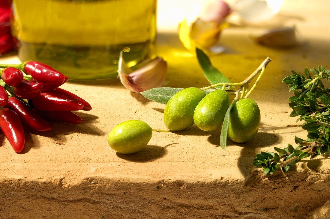 Still life with olives, chillies and herbs