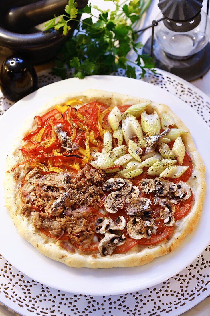 A round pizza with four different toppings