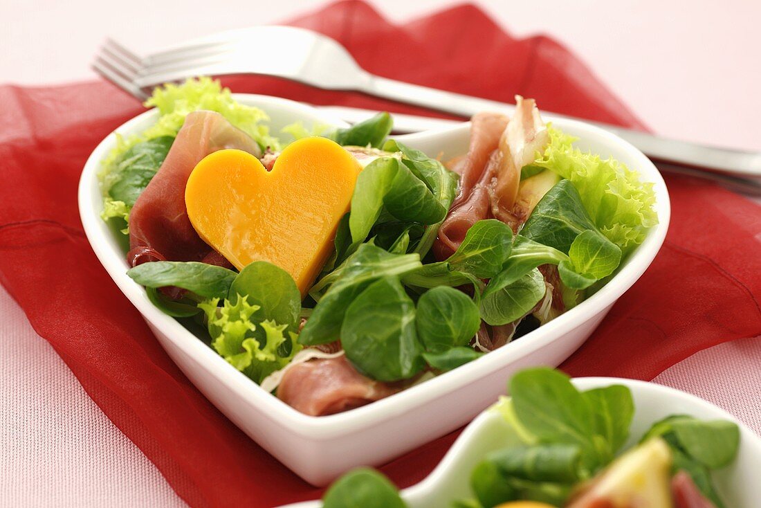 Salad leaves with ham and cheese heart