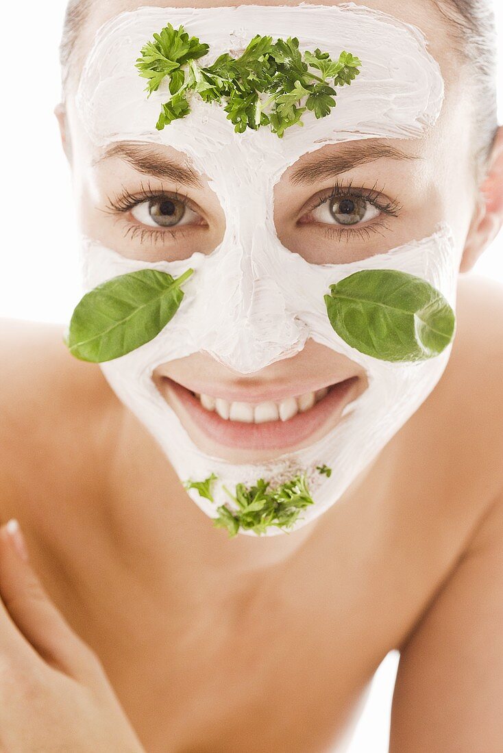 Young woman with herbal facial mask