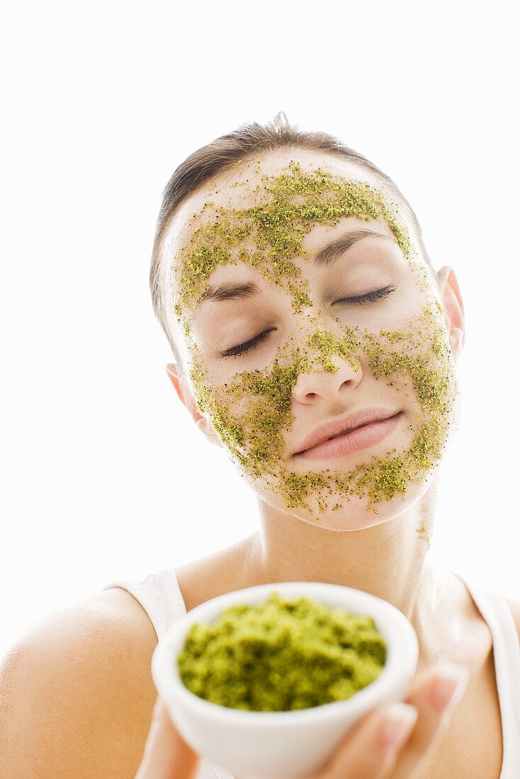 Young woman with herbal face mask