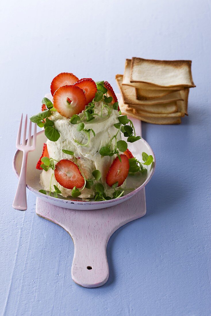 Soft cheese with strawberries and cress, crackers