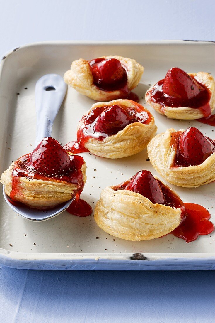 Strawberry puff pastry tarts on baking tray