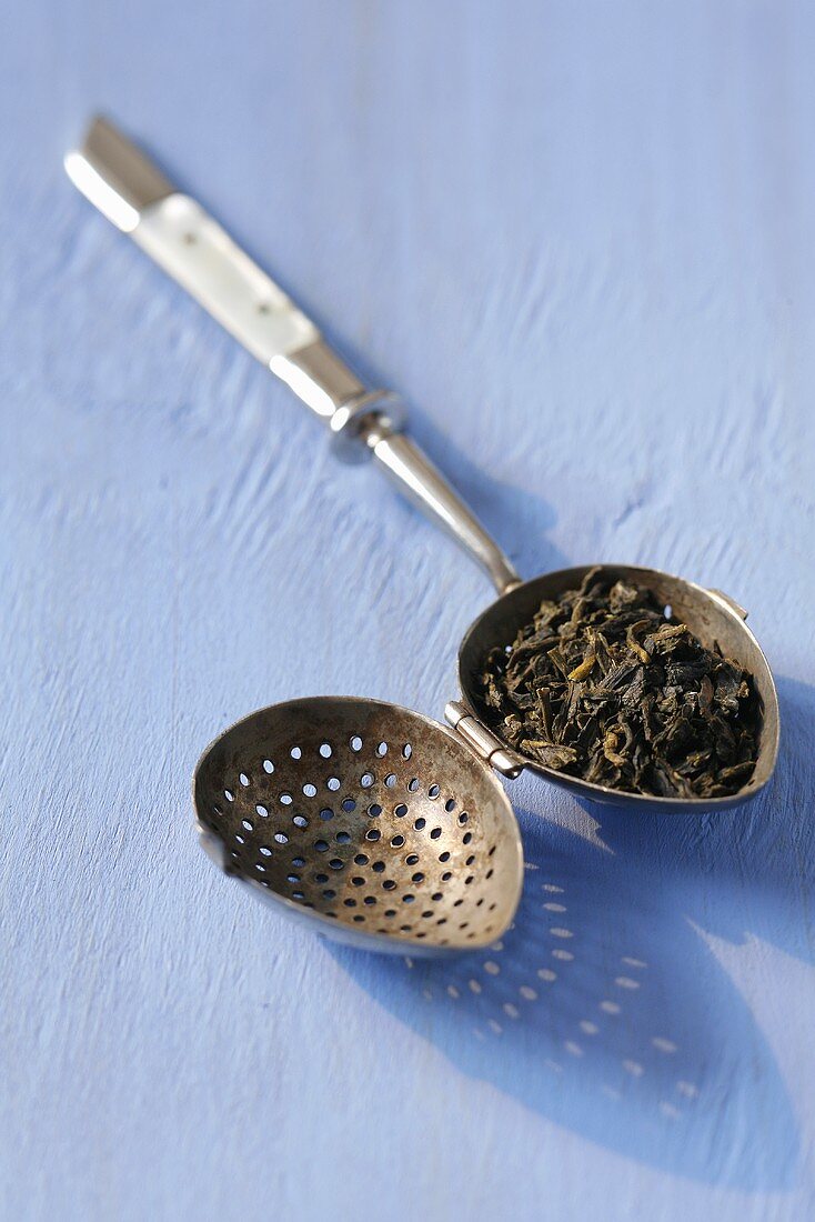 Green tea in an old tea infuser