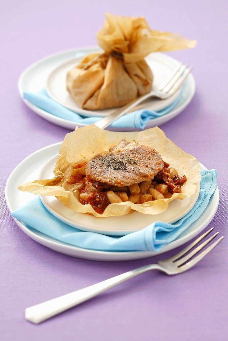 Veal escalope with beans cooked in baking parchment