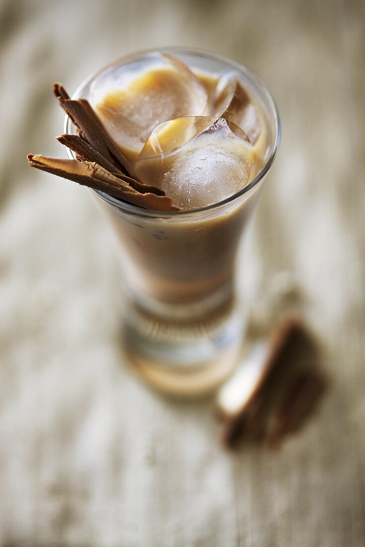 Baileys with ice cubes and cinnamon sticks