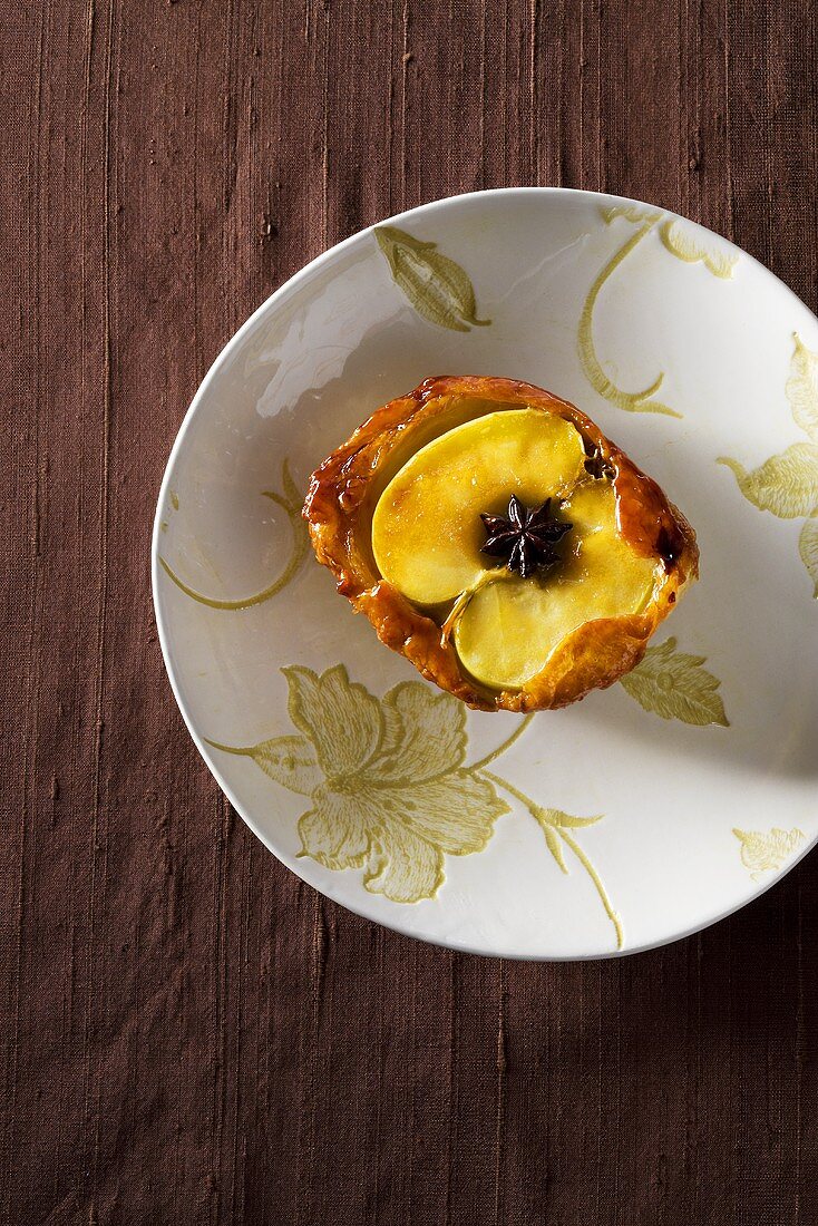 Apple in batter with star anise (overhead view)