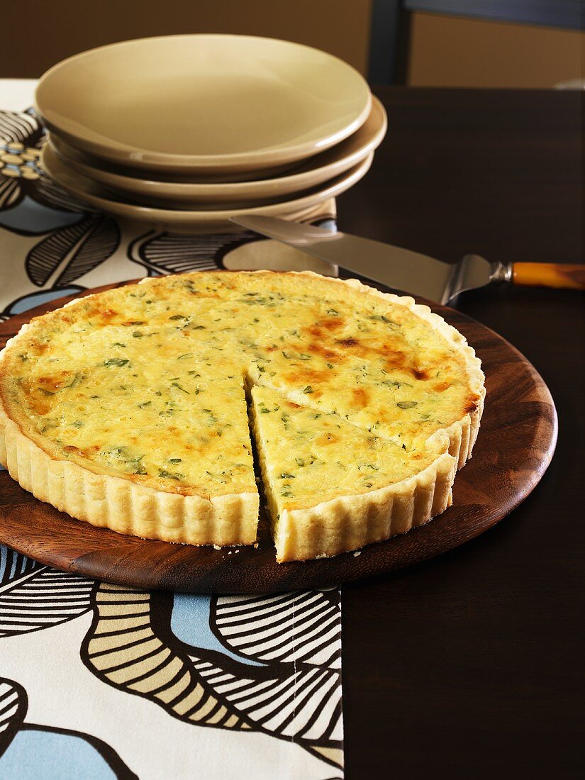 Cheese and herb tart, a piece cut