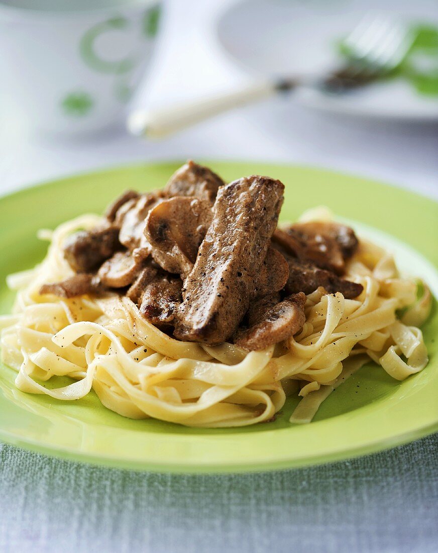 Beef and mushrooms on ribbon pasta
