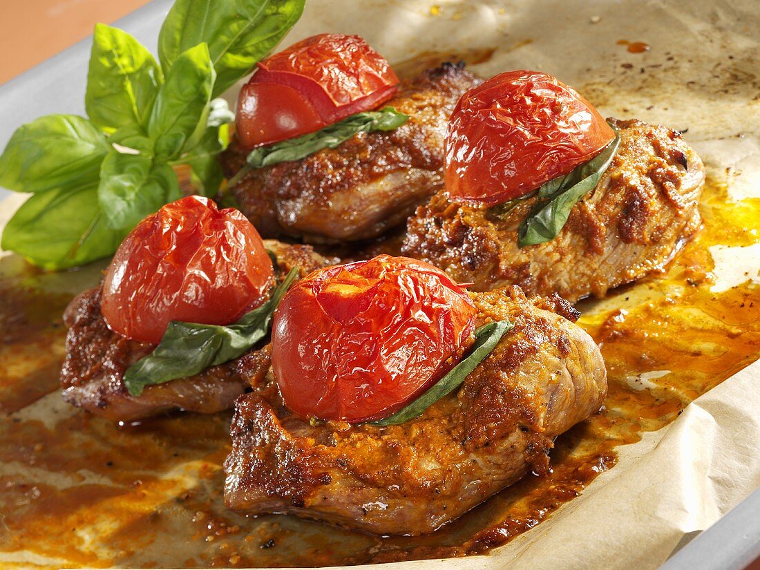 Baked turkey steaks with red pesto, basil and tomatoes