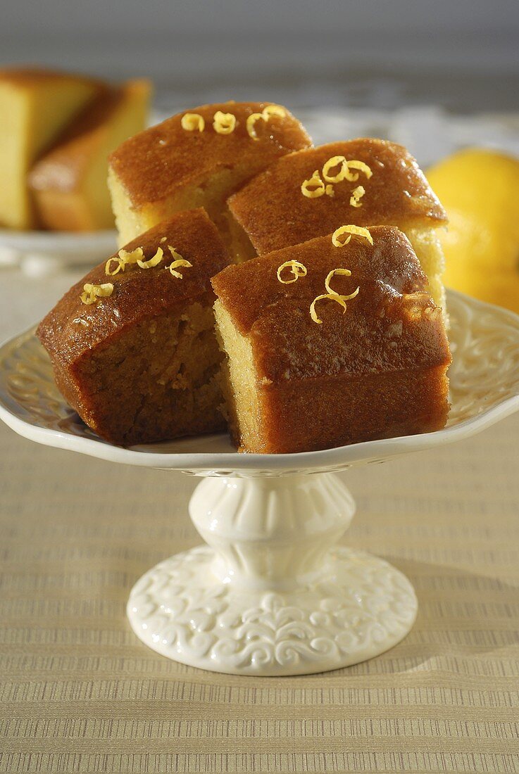 Several pieces of citrus cake on cake stand