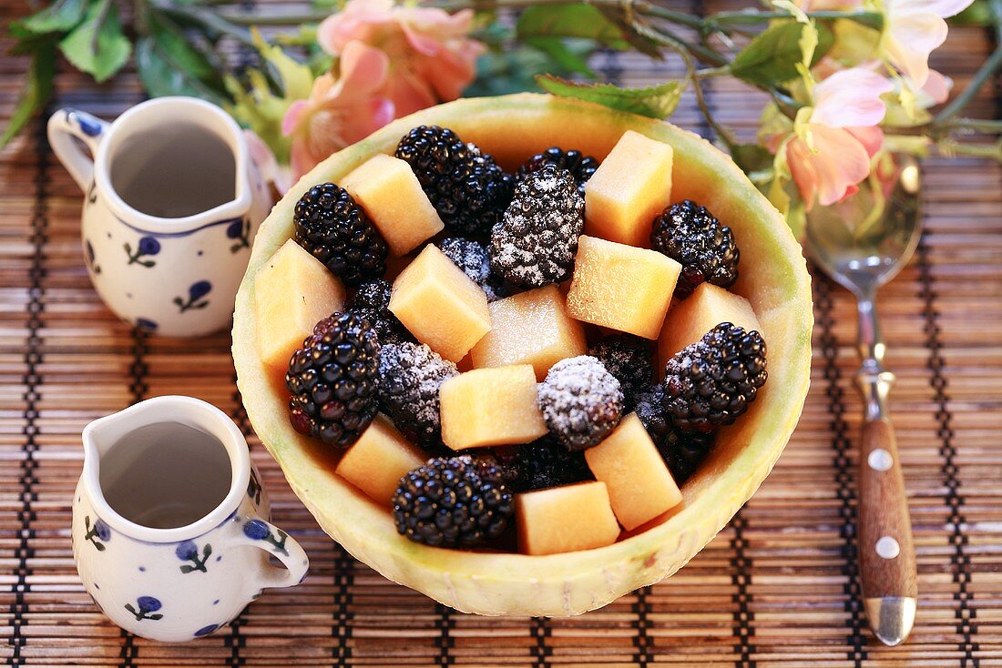Melon and blackberry salad with icing sugar