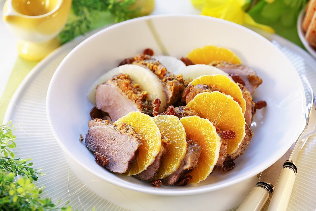 Duck breast with orange slices and raisins