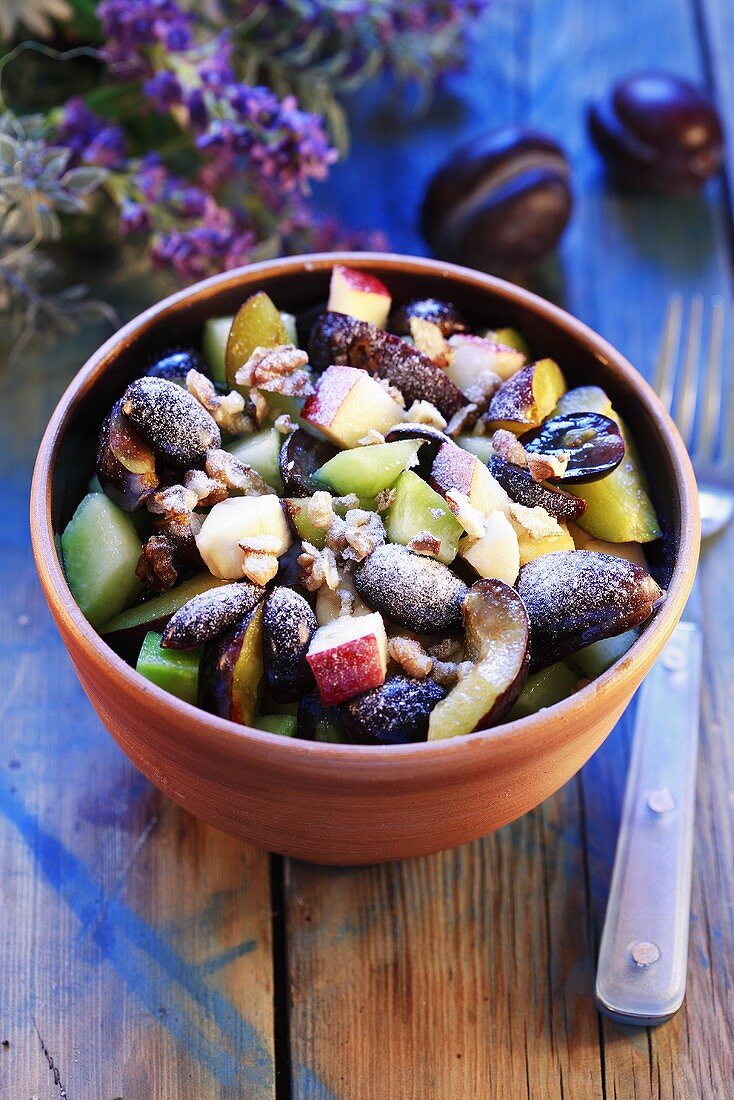 Fruit salad with nuts and icing sugar