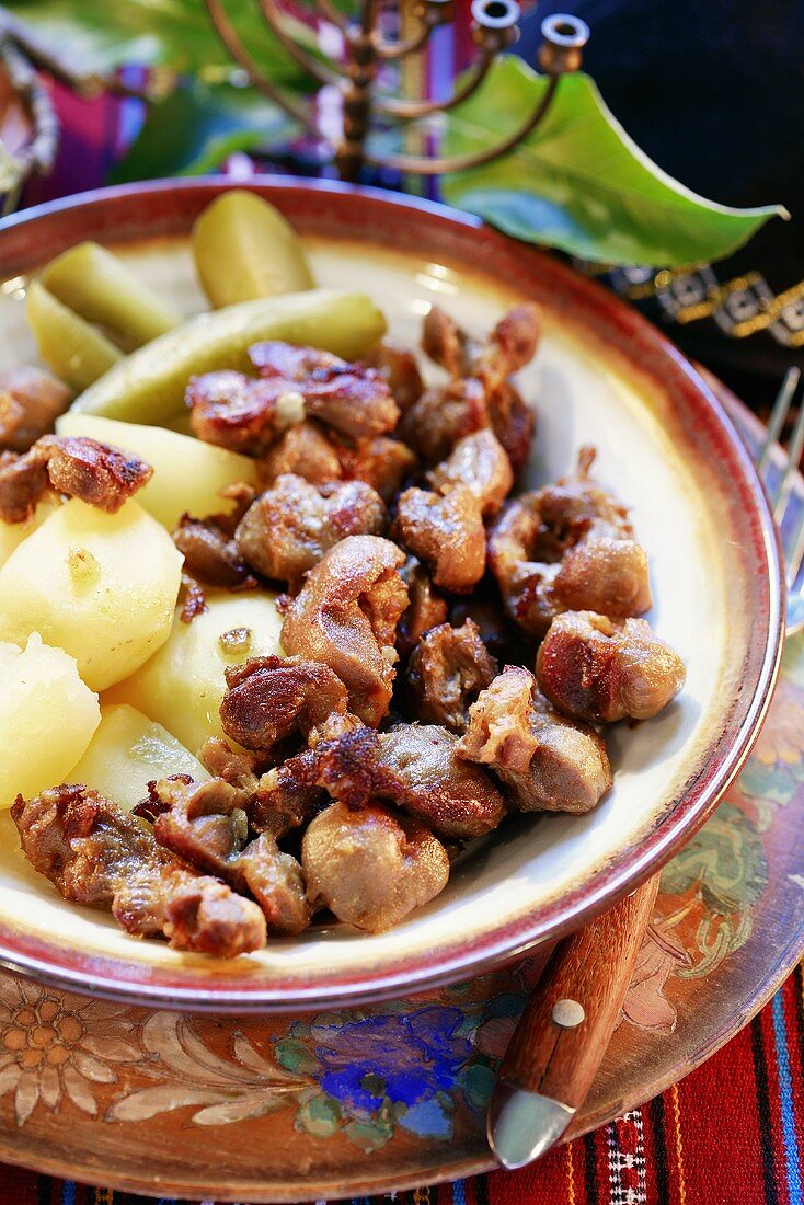 Goose giblets with boiled potatoes and gherkins