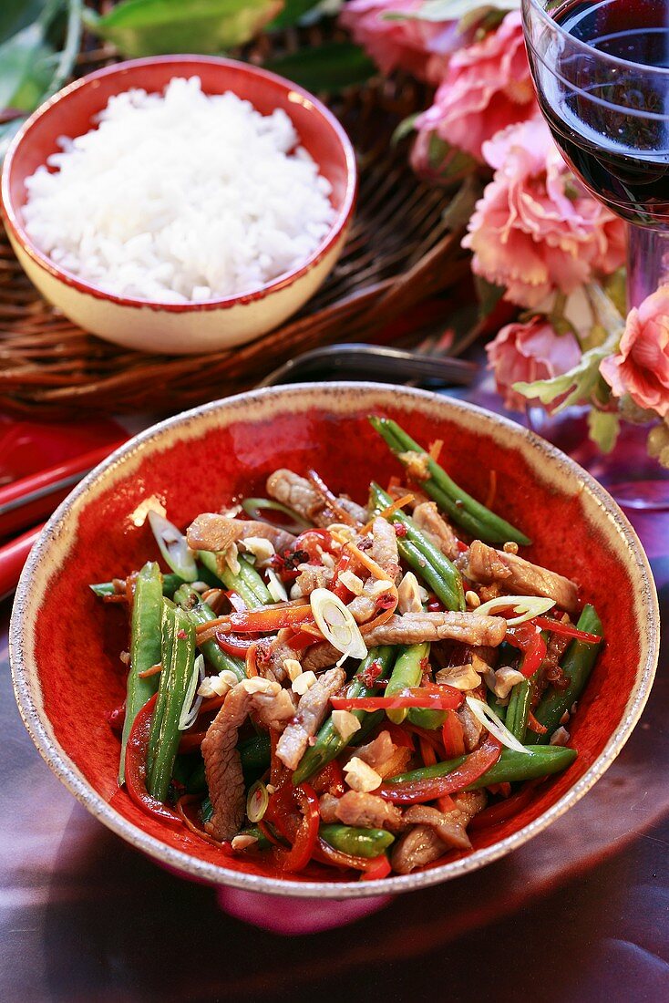 Strips of pork with green beans and nuts, rice
