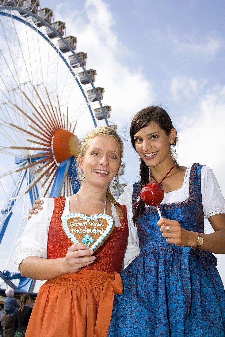 Two women in front of big wheel (Oktoberfest, Munich)