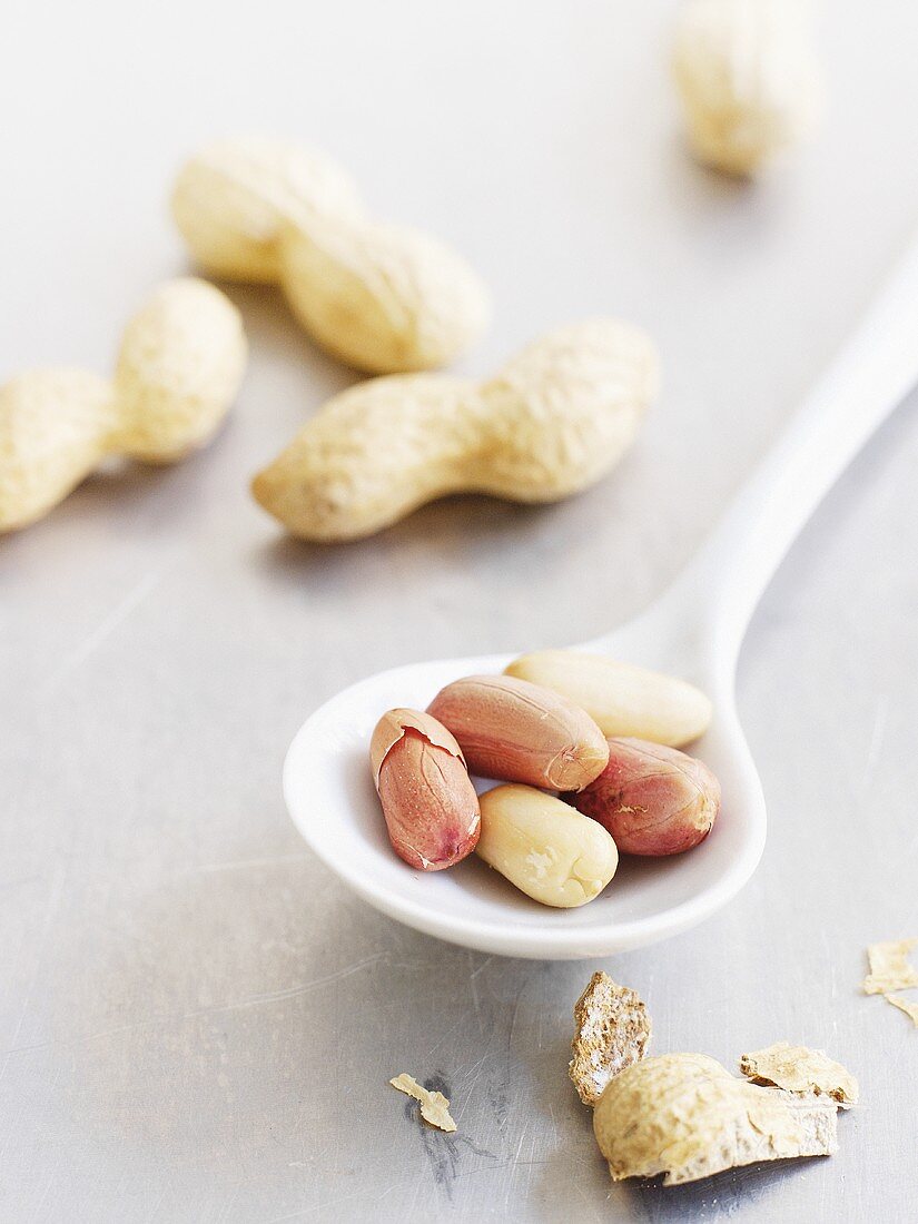 Peanuts on and beside spoon