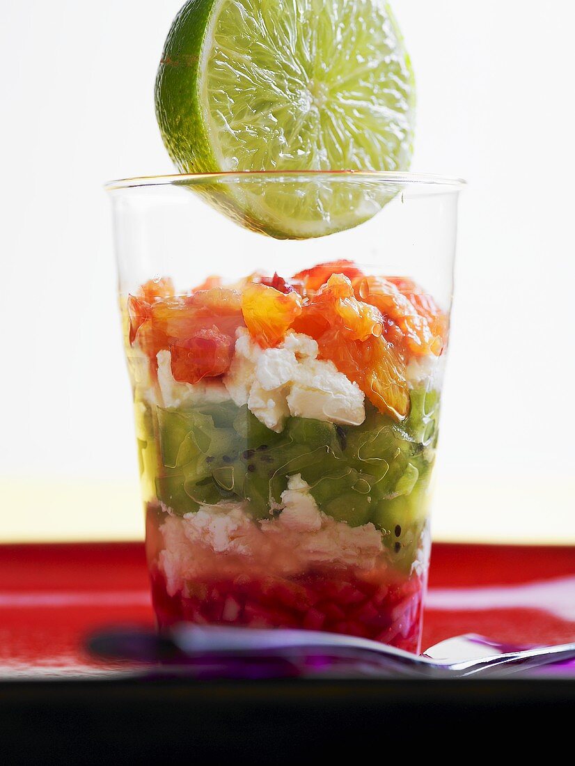 Soft cheese with fruit and lime juice in a glass