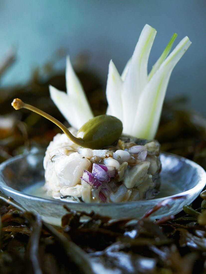 Clam tartare with onions and caper berries