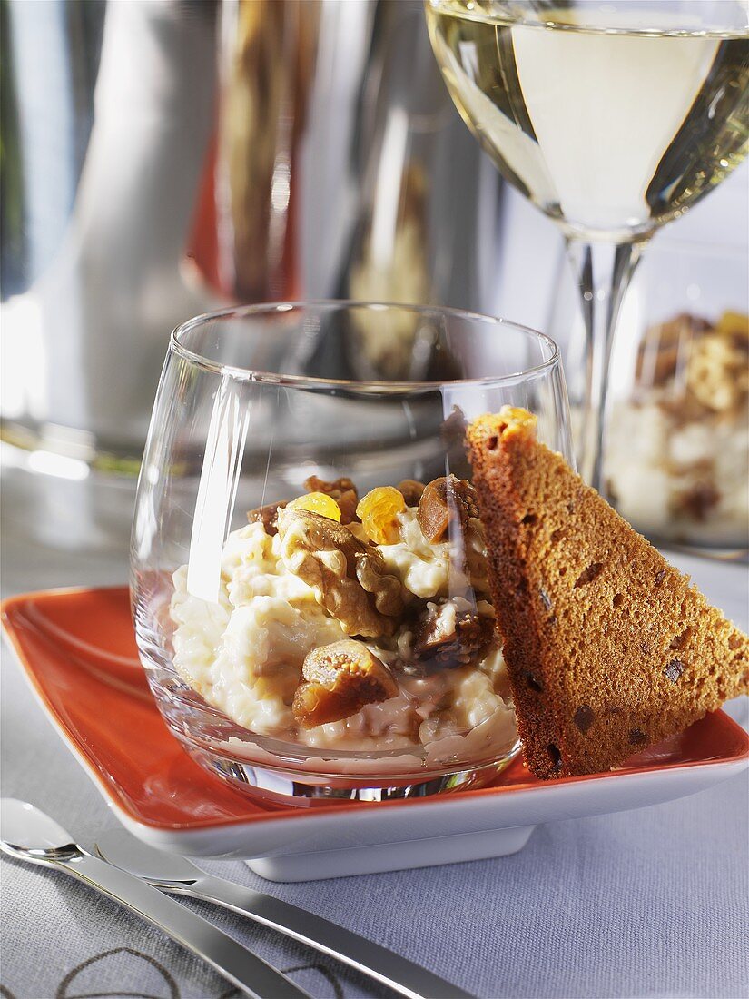 Soft cheese with nuts and dried fruit in glass