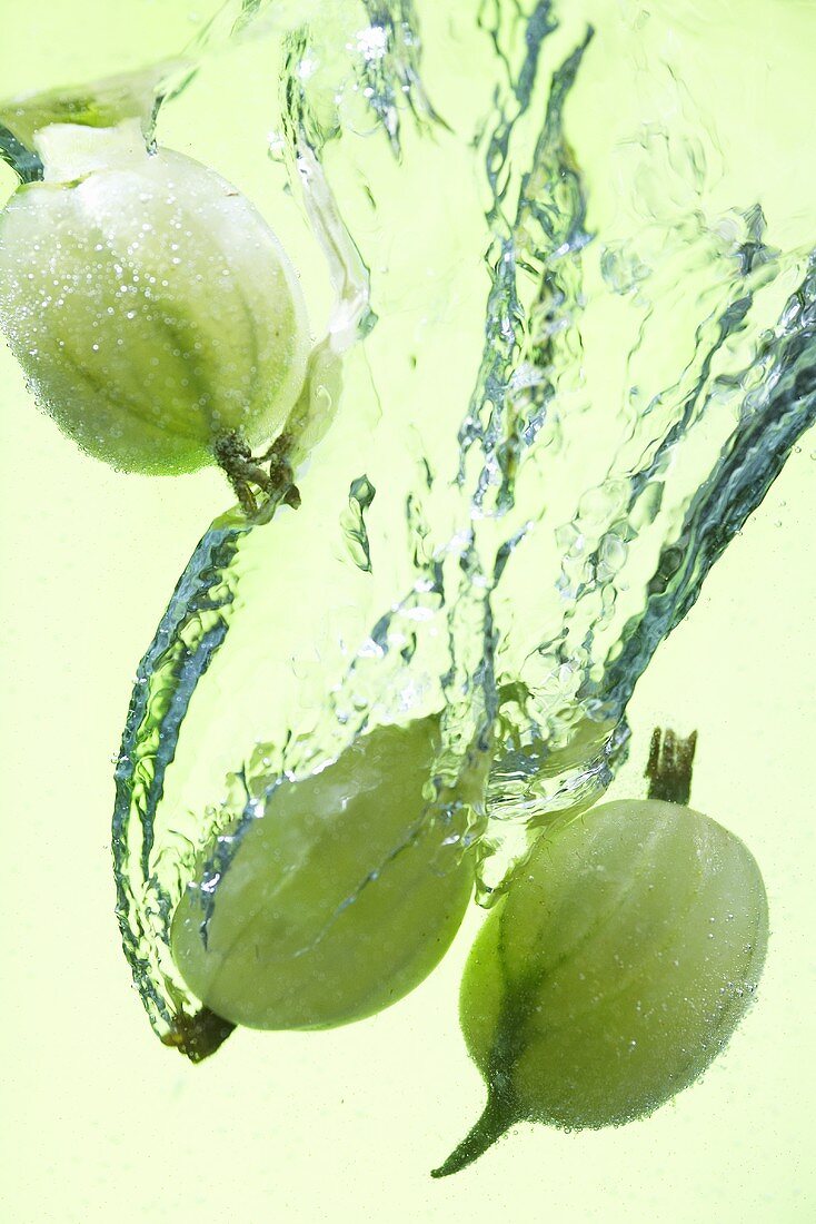 Gooseberries falling into water