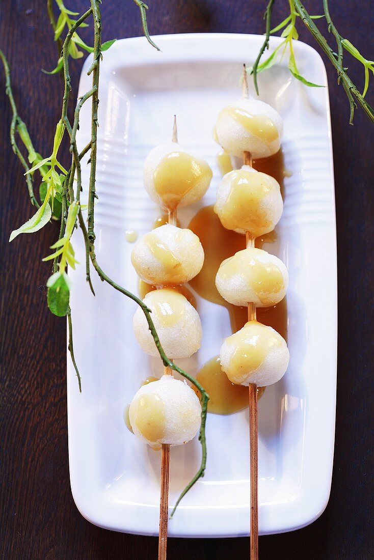 Skewered rice balls with sweet sauce