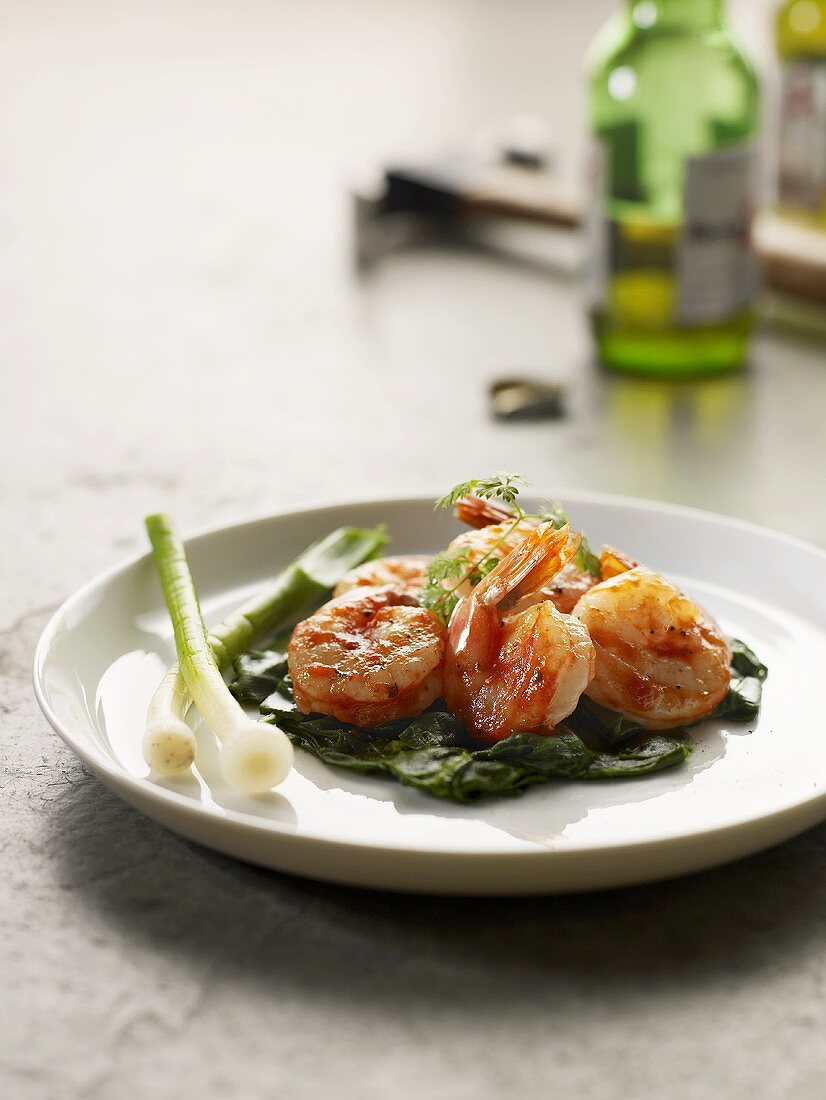 Cooked prawns with spinach and spring onions