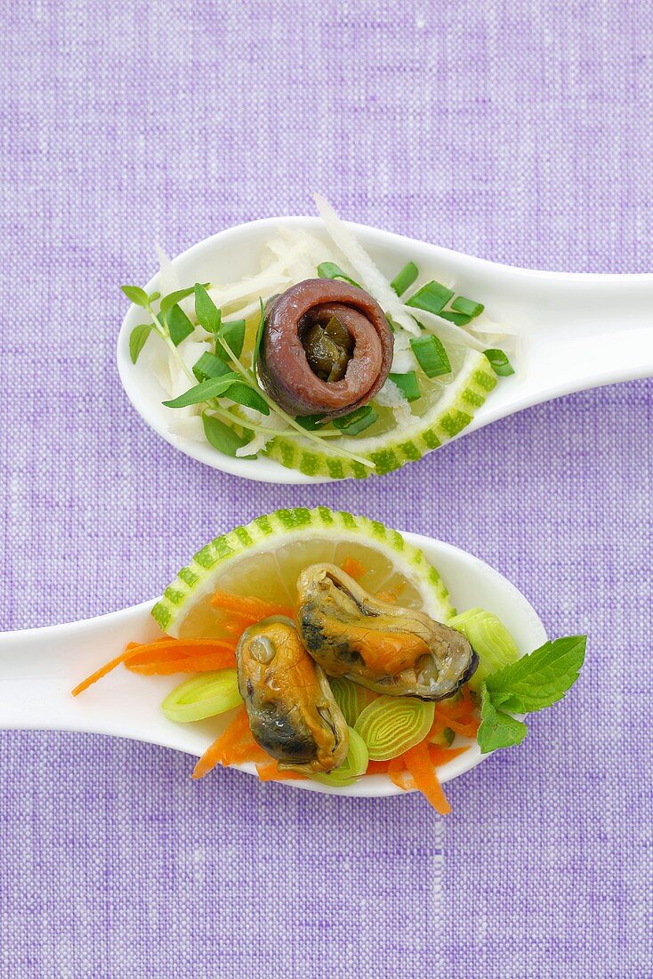 Marinated shellfish and anchovy on two spoons