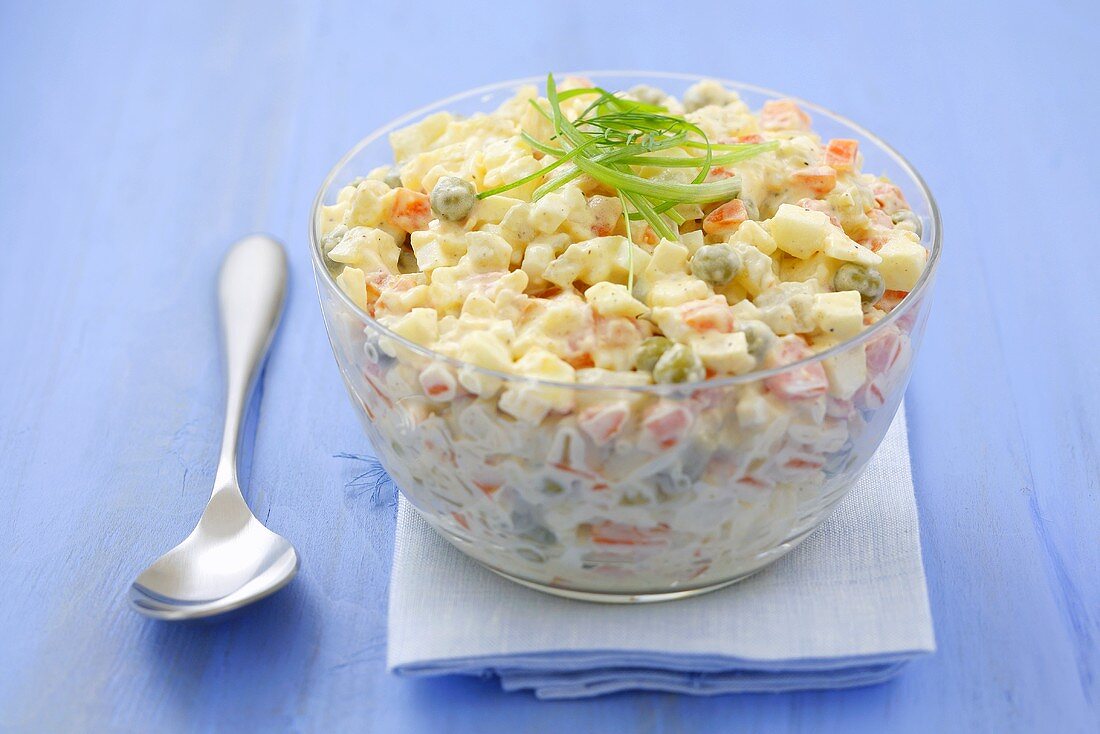 A bowl of vegetable salad with apple and egg in mayonnaise