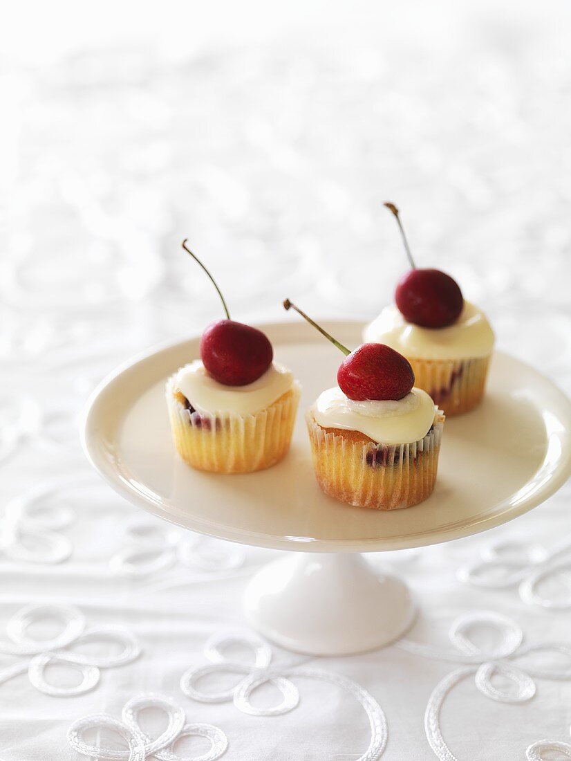 Mini cherry cupcakes on a cake stand