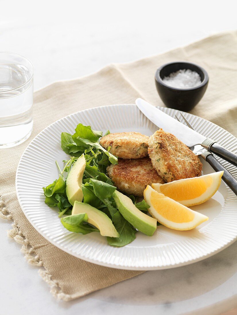 Fish cakes with dandelion and avocado salad