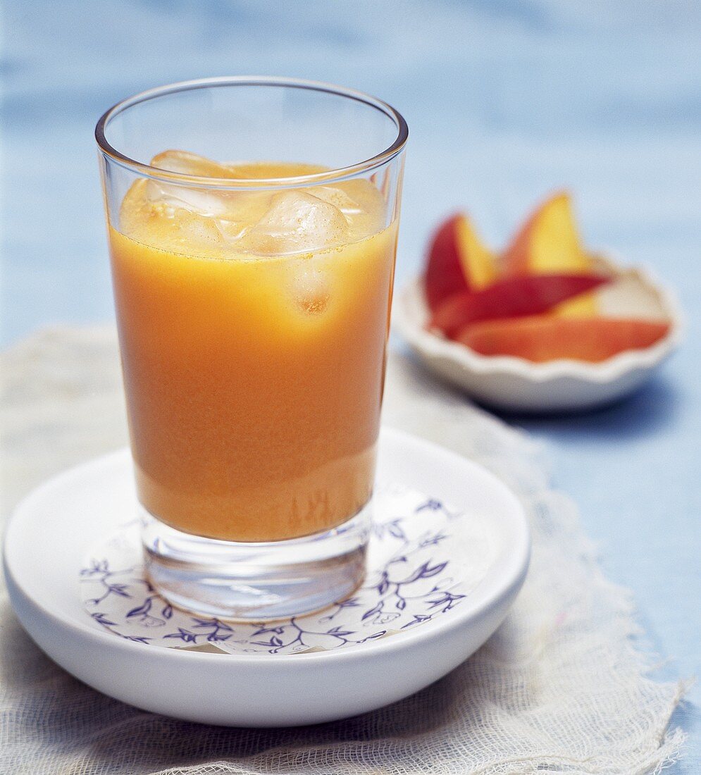 Peach and carrot juice with ice cubes