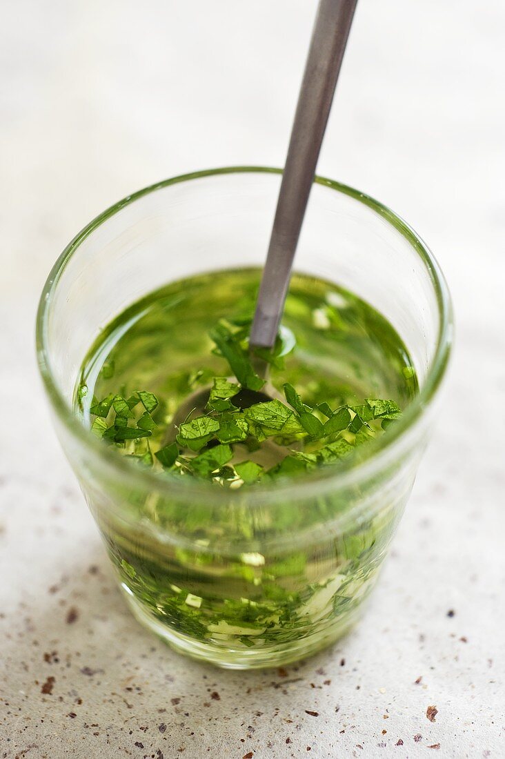 Parsley and garlic marinade in a glass